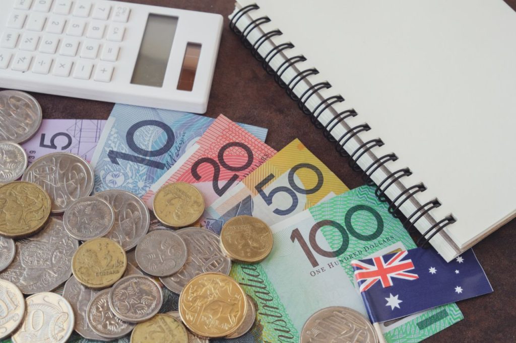 Australian currency with calculator and notebook