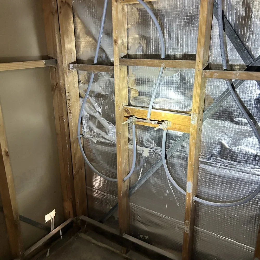New hot and cold water supply lines installed in wall frame